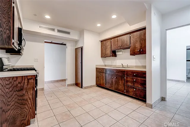 a large room with wooden floor and natural light
