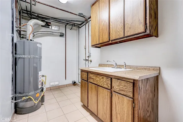 a spacious bedroom with a bed and a chandelier