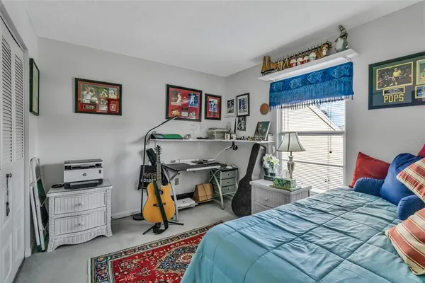 a bedroom that has a bed and a desk in it