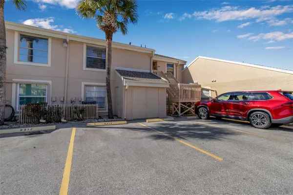 a view of a cars park in front of a building
