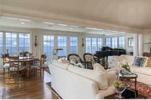 a living room with furniture a large window and a table