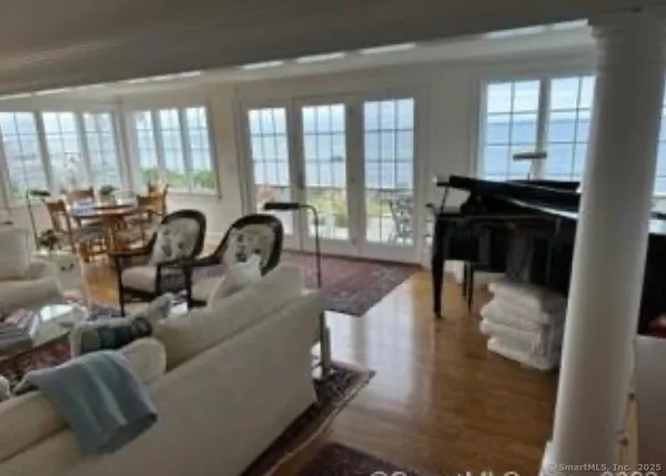 a living room with furniture and a floor to ceiling window