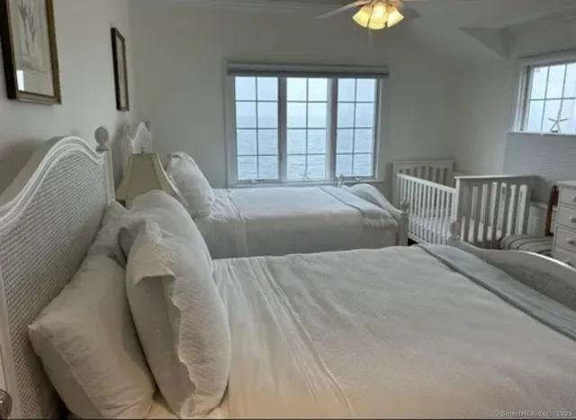 a bed sitting in a bedroom next to a window
