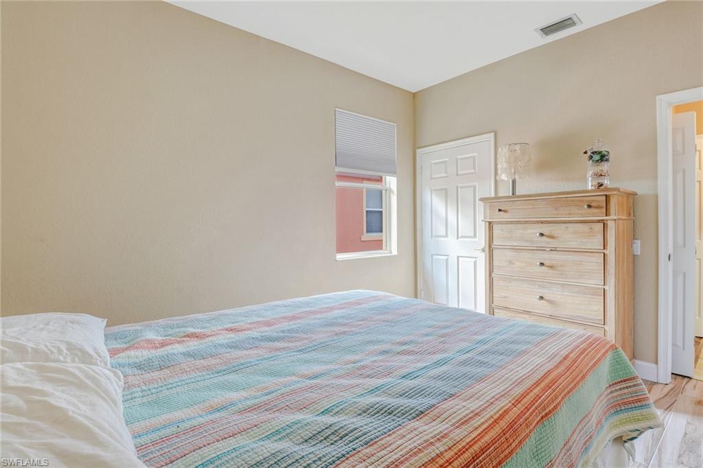 10037 Heather Lane, Unit 4 Naples, FL 34119 - Photo 15 of 24 a bedroom with a bed and a closet