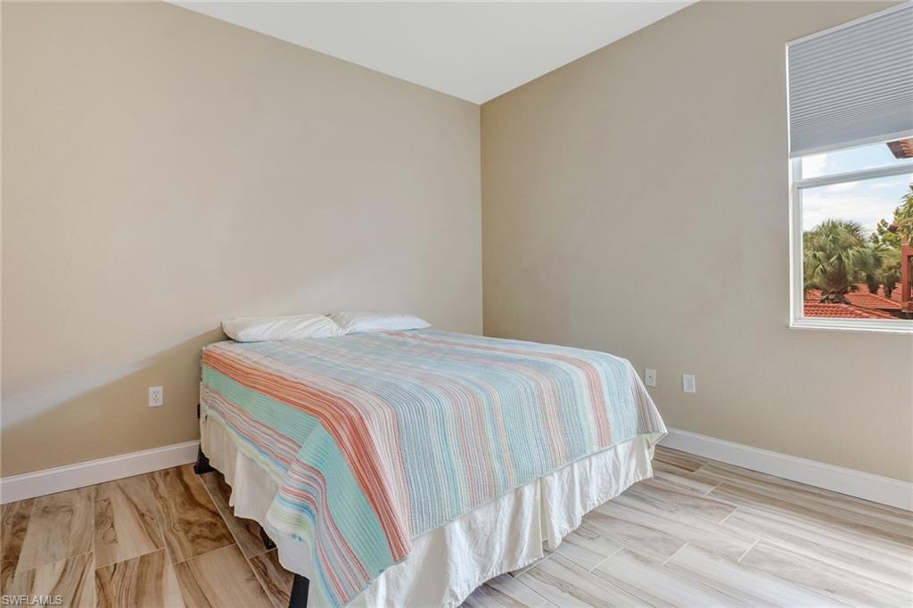 10037 Heather Lane, Unit 4 Naples, FL 34119 - Photo 16 of 24 a bedroom with a bed and a window