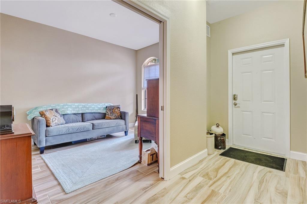 10037 Heather Lane, Unit 4 Naples, FL 34119 - Photo 20 of 24 a living room with furniture and a wooden floor