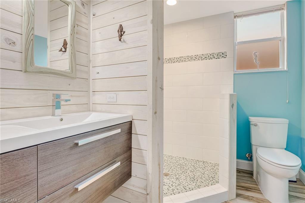 10037 Heather Lane, Unit 4 Naples, FL 34119 - Photo 2 of 24 a bathroom with a sink and a toilet