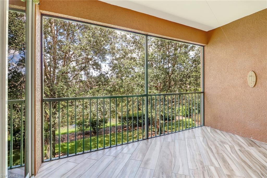 10037 Heather Lane, Unit 4 Naples, FL 34119 - Photo 23 of 24 a view of a balcony with wooden floor