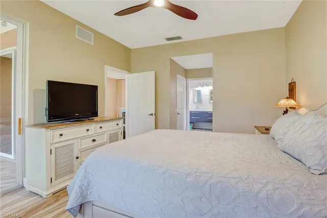 a bedroom with a flat screen tv and a bed