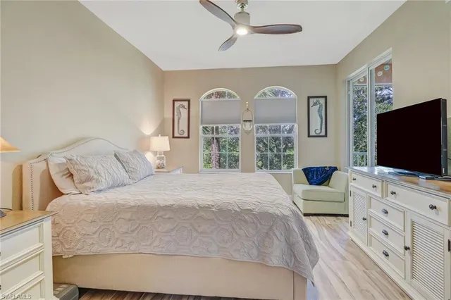 a bedroom with a large bed and a flat screen tv