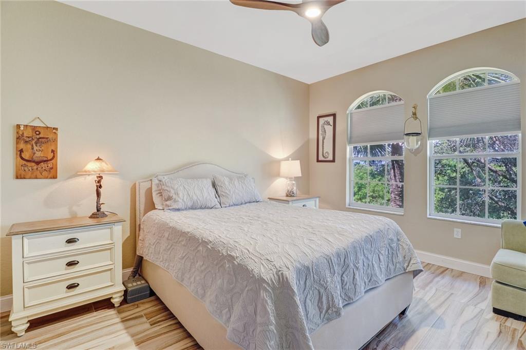 10037 Heather Lane, Unit 4 Naples, FL 34119 - Photo 5 of 24 a bedroom with a bed and a dresser