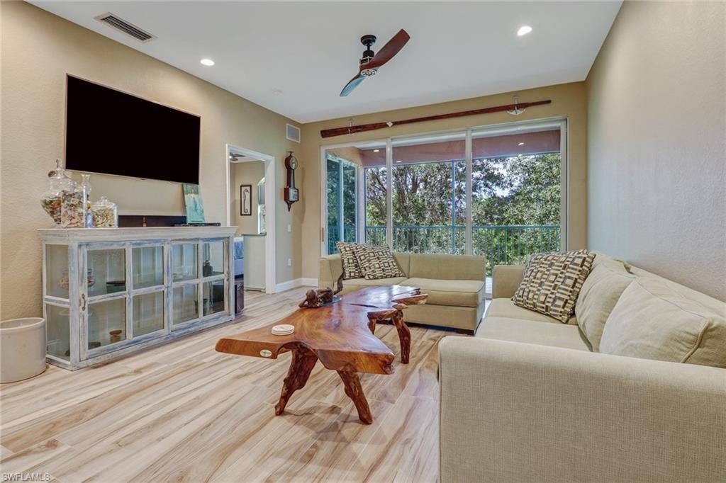 10037 Heather Lane, Unit 4 Naples, FL 34119 - Photo 8 of 24 a living room with furniture and a flat screen tv