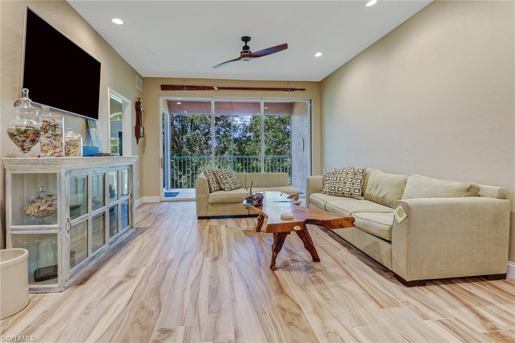 10037 Heather Lane, Unit 4 Naples, FL 34119 - Photo 9 of 24 a living room with furniture and a flat screen tv