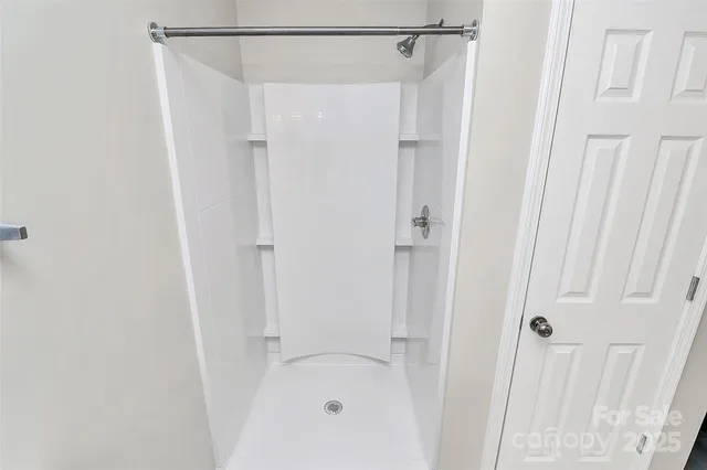 a bathroom with a glass shower door