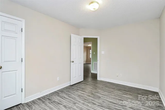 a view of an empty room and wooden floor