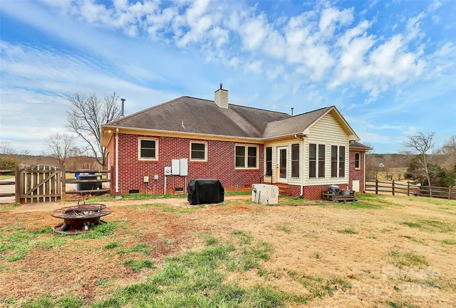 a view of a house with a yard patio and fire pit