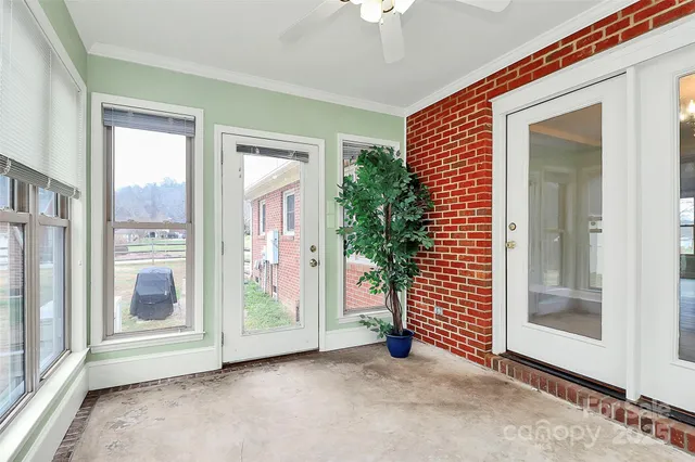 an empty room with windows and entryway