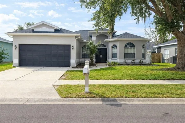 a front view of a house with a yard and garage