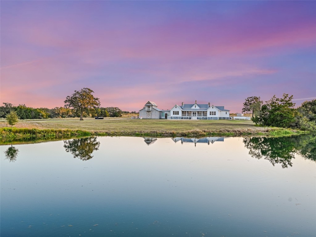 a view of a lake with houses in the background