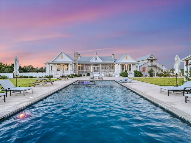 a view of a house with backyard and sitting area