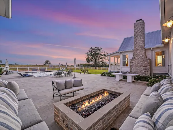 swimming pool with outdoor seating and yard in the back