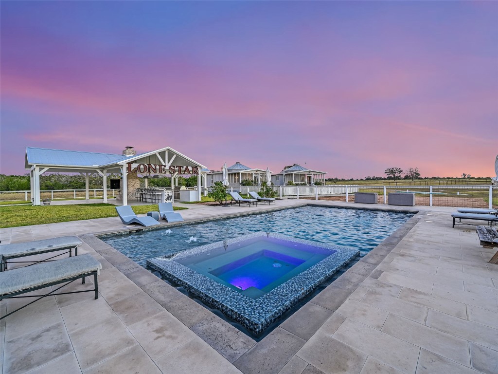 314 Big Sky Ranch Road Smithville, TX 78957 - Photo 25 of 40 swimming pool with outdoor seating and yard in the back