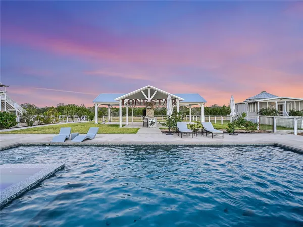 a view of a porch with furniture and a fireplace