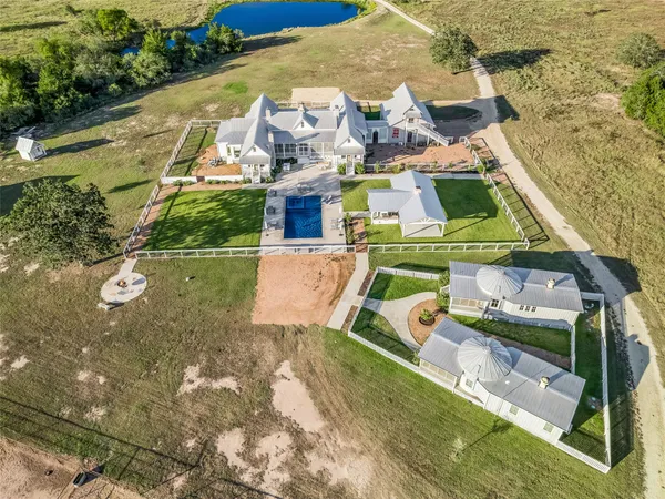an aerial view of a house with swimming pool