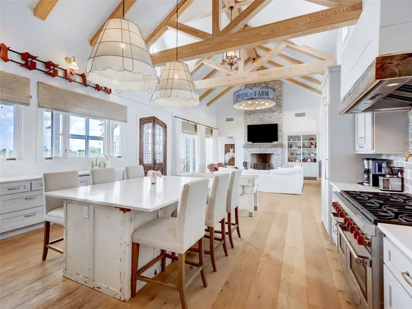 a large kitchen with a table and chairs in it