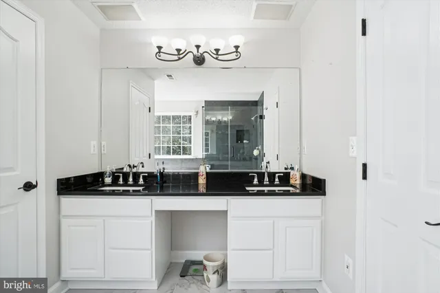 a bathroom with a sink toilet vanity and shower
