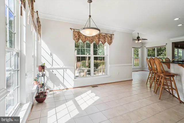 a view of a dining room with furniture wooden floor and a chandelier