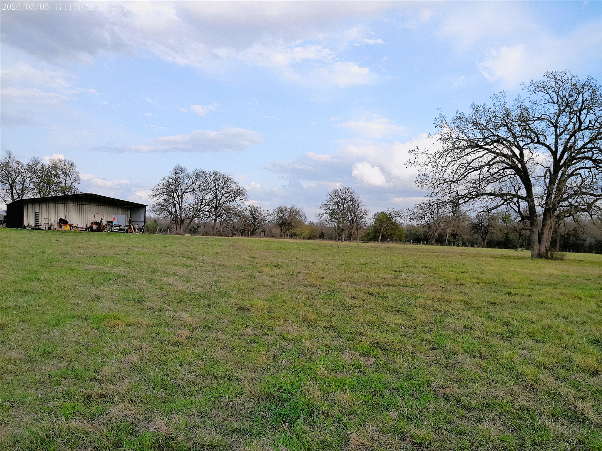 1042 Los Ranchitos Road Cameron, TX 76520 - Photo 21 of 40 View of green lawn featuring a view of countryside and an outbuilding