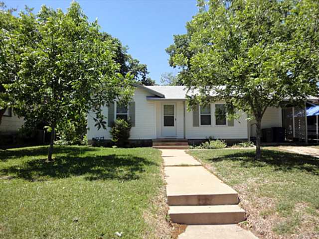6402 Laird Drive Austin, TX 78757 - Photo 1 of 1 a white house with a yard and large trees