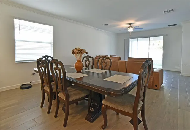 a view of a dining room with furniture and wooden floor
