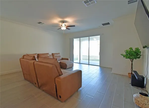 a living room with furniture potted plant and window