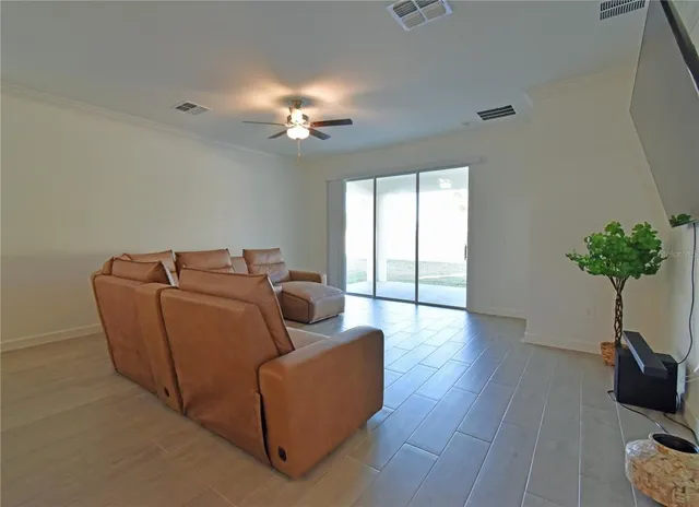 a living room with furniture potted plant and window