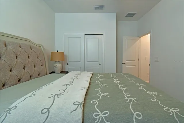 a bedroom with a bed and cabinets