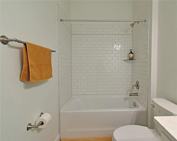 a bathroom with a toilet and a bathtub