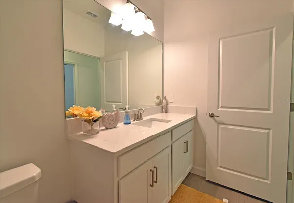 a bathroom with a sink toilet and mirror