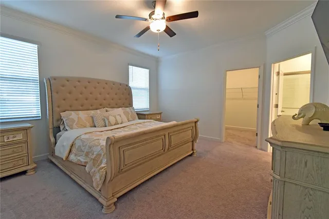 a spacious bedroom with a bed and a dresser