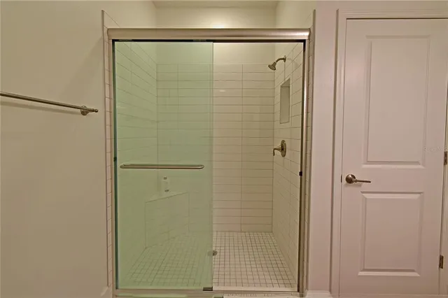 a bathroom with a glass shower door