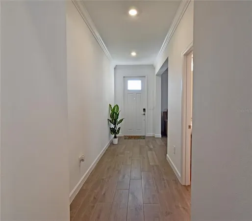 a view of a hallway with wooden floor