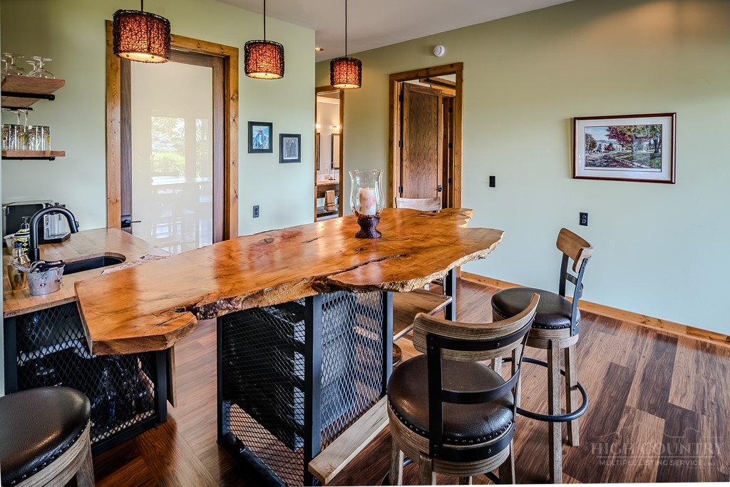 179 Adams Road Vilas, NC 28692 - Photo 32 of 50 a view of a dining room with furniture and wooden floor