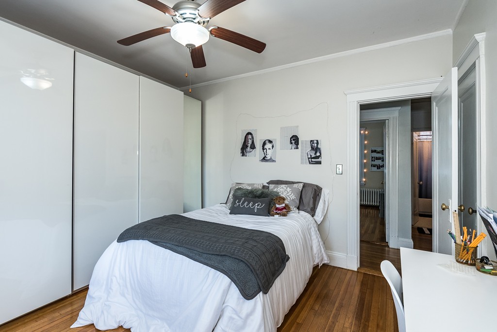 1982 Commonwealth Avenue, Unit 4 Boston, MA 02135 - Photo 11 of 17 a bedroom with a bed and a chandelier