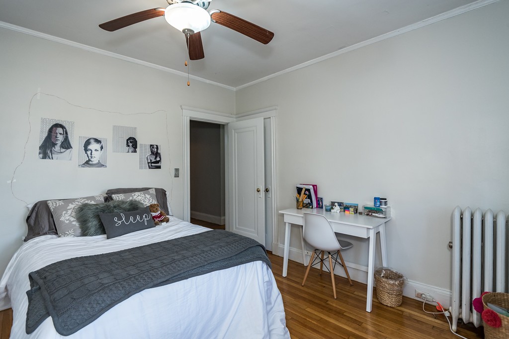 1982 Commonwealth Avenue, Unit 4 Boston, MA 02135 - Photo 12 of 17 a bedroom with a bed and a table in it