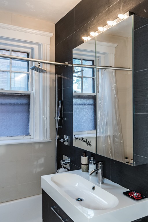 1982 Commonwealth Avenue, Unit 4 Boston, MA 02135 - Photo 13 of 17 a bathroom with a sink and a mirror