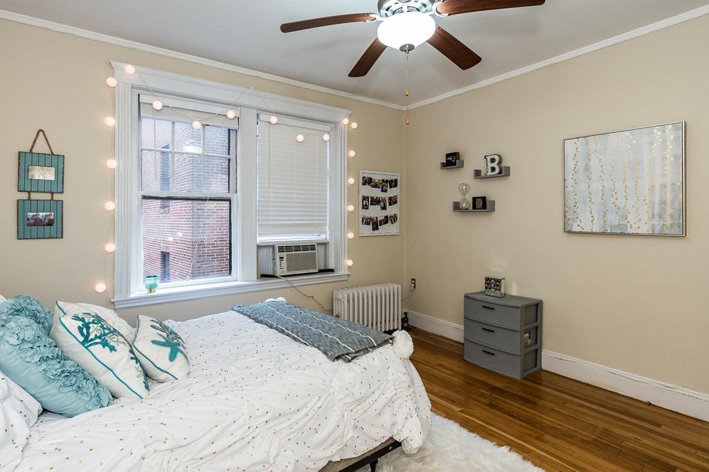 1982 Commonwealth Avenue, Unit 4 Boston, MA 02135 - Photo 15 of 17 a spacious bedroom with a bed and ceiling fan
