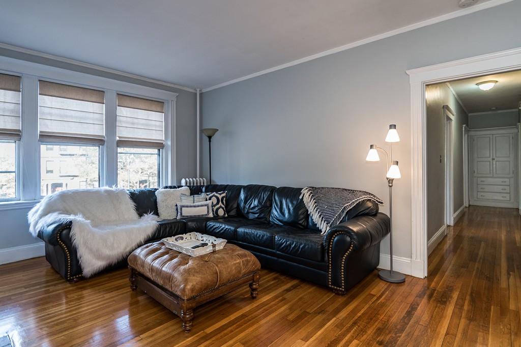 1982 Commonwealth Avenue, Unit 4 Boston, MA 02135 - Photo 3 of 17 a living room with couches and a large window