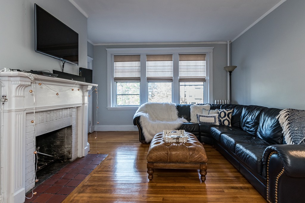 1982 Commonwealth Avenue, Unit 4 Boston, MA 02135 - Photo 5 of 17 a living room with furniture flat screen tv and a fireplace