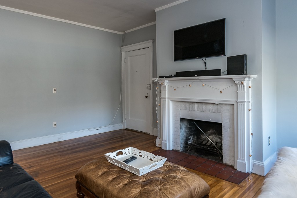 1982 Commonwealth Avenue, Unit 4 Boston, MA 02135 - Photo 6 of 17 a living room with furniture and a fireplace